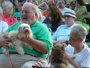 Pastor Ed and Debbie take their Havanese to the outdoor concert.