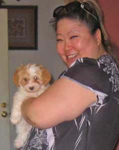 Amy greets her Havanese puppy, Coco, as they bond and head for home.